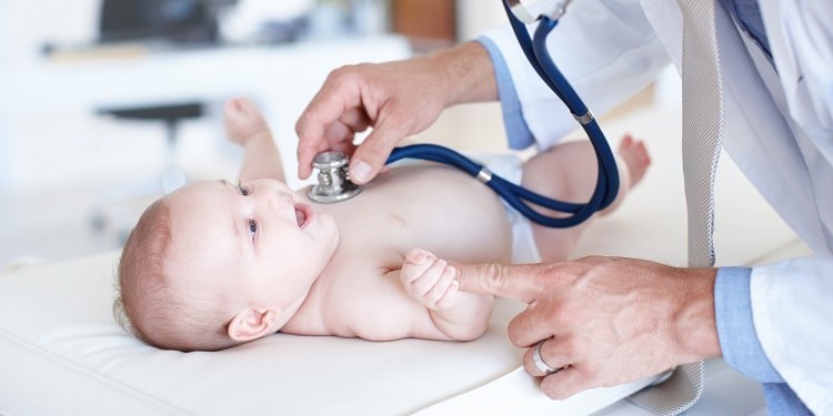 doctor checking infant 